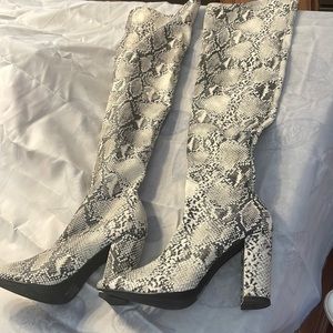 Venus over the knee snake print boots.